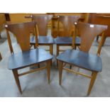 A set of four teak dining chairs