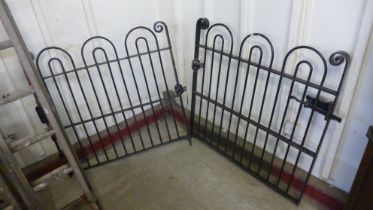 A pair of 1930s bow top wrought iron gates