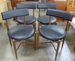 A set of four G-Plan Fresco teak and black vinyl dining chairs