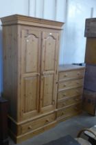 A pine chest of drawers and a wardrobe