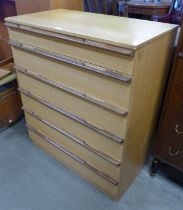 A teak chest of drawers