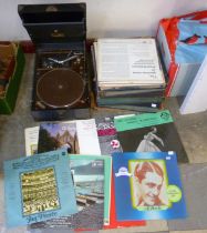 A vintage H.M.V. portable gramophone and assorted records