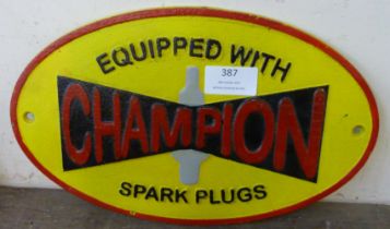 A painted cast iron Champion Spark Plugs advertising sign