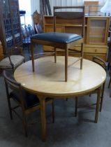 A McIntosh teak extending dining table and four teak and vinyl chairs