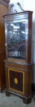 An Edward VII inlaid mahogany freestanding corner cabinet