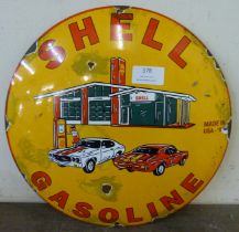A circular enamelled metal Shell Gasoline advertising sign
