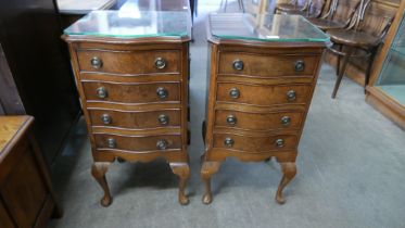 A pair of small burr walnut serpentine chests of drawers