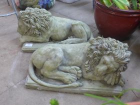 A pair of concrete garden figures of recumbent lions