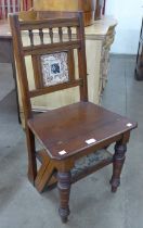 A Victorian Aesthetic Movement mahogany metamorphic library chair/step, inset with Mintons style