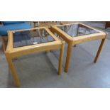 A pair of Ercol elm and glass topped occasional tables