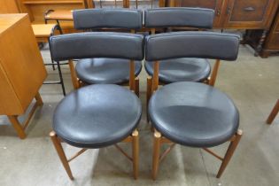 A set of four G-Plan Fresco teak and black vinyl dining chairs