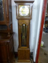 An oak triple weight longcase clock