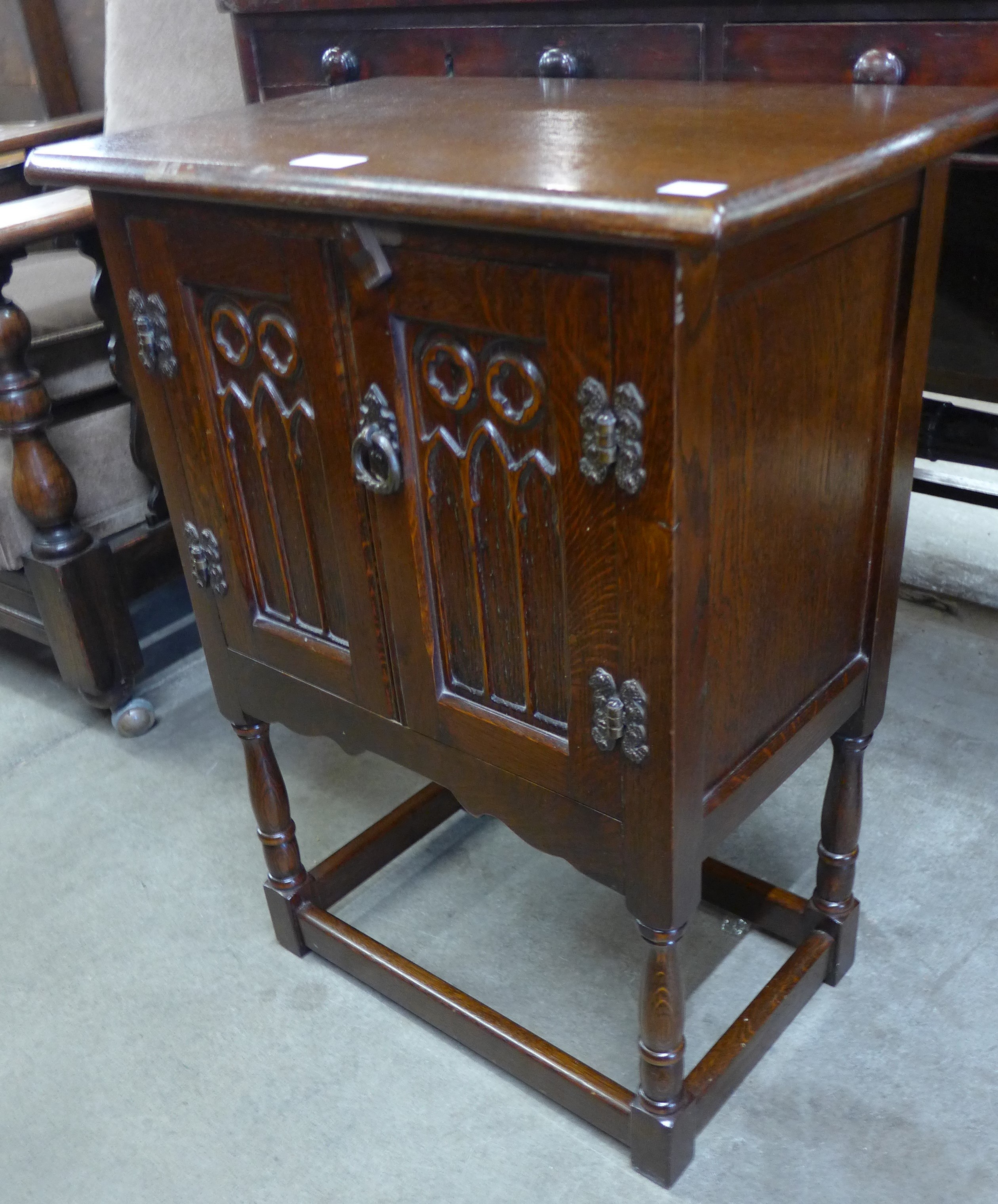 A small 17th Century style carved oak cupboard