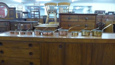 Assorted small brass and copper coated saucepans