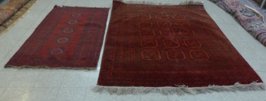 Two eastern red ground rugs, 288 x 202cms and 225 x 118cms