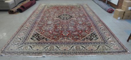 A large eastern red ground rug, 515 x 319cms