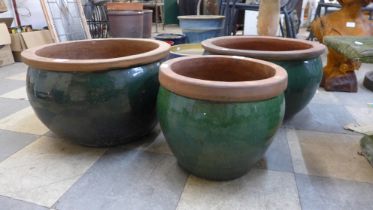 Three green glazed terracotta garden planters