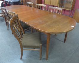 A Swedish Hugo Troeds teak extending Ove dining table, designed by Nils Jonsson and six teak