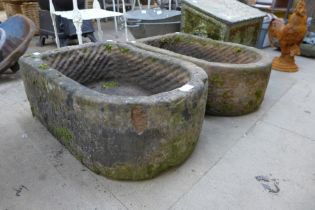 A pair of D-shaped sandstone garden troughs