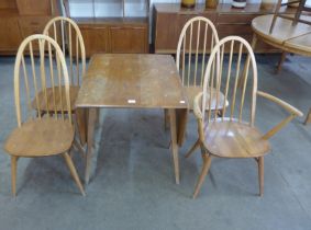 An Ercol Blonde elm and beech Windsor drop-leaf table and four Ercol Quaker chairs