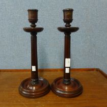 A pair of late Victorian mahogany candlesticks