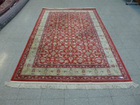 A red ground rug, 287 x 176cms