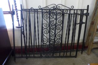 A pair of painted wrought iron garden gates