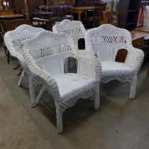 A et of four painted wicker chairs