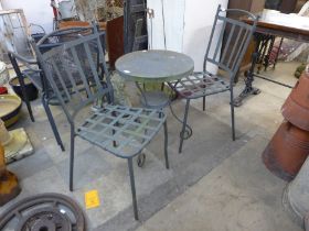 A wrought alloy garden table and two chairs