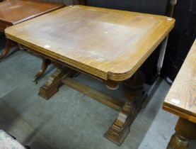 A carved oak draw-leaf table