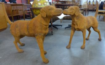 A pair of large cast iron garden figures of dogs