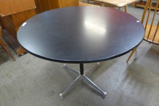 An Eames style aluminium and black lacquered circular dining table