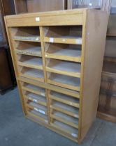 An oak and plywood sixteen drawer shop cabinet