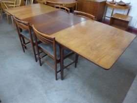 A McIntosh rosewood extending T3 model dining table and four chairs, designed by Tom Robertson,