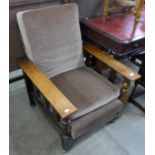 An Arts and Crafts oak reclining fireside armchair
