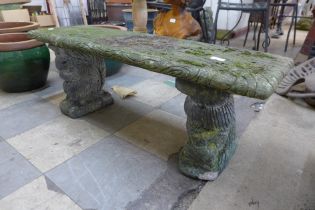 A concrete pedestal garden bench