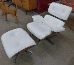 A Charles & Ray Eames style simulated walnut and white leather revolving lounge chair and ottoman