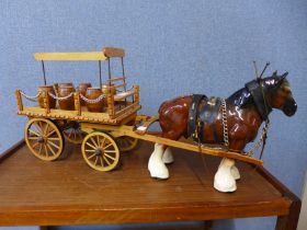 A porcelain Shire horse with wooden cart