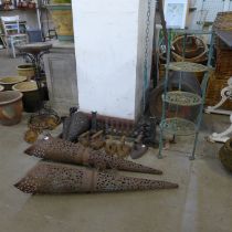 A pair of steel cone shaped oil burners, a pair of cast iron wall sconces, a jardiniere stand, a