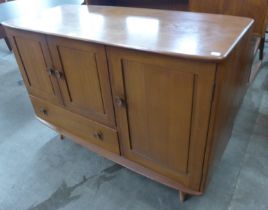 An Ercol elm Windsor sideboard