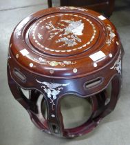 A Chinese hardwood and mother of pearl inlaid barrel shaped stool