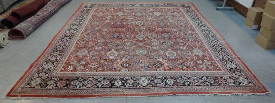 A large eastern red ground rug, 425 x 317cms