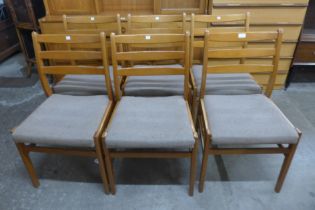 A set of six teak dining chairs