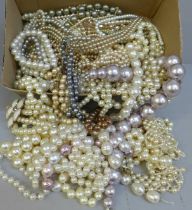 A box of faux pearl necklets and bracelets