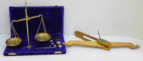 A set of balance scales and weights and a gilt brass section of balance scales