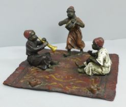 After Bergman, a cold painted bronze of three musicians on a carpet, signed Namgreb to base, 16.