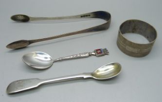 A pair of silver sugar bows, a silver napkin ring, an early 19th Century silver mustard spoon and