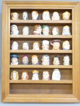 A collection of 29 thimbles in the form of famous figures, all Staffordshire and signed inside,