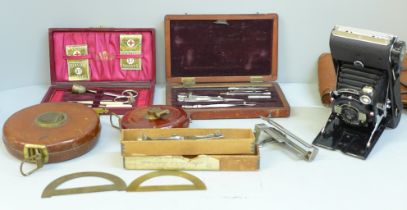 A collection of measuring implemenets, draughtsman's tools, tape measures, etc.