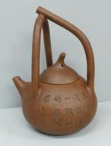 A Chinese clay Yixing teapot, handle repaired